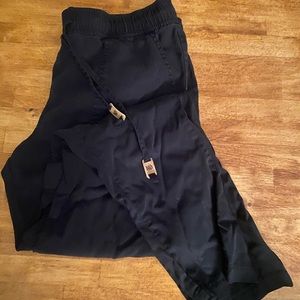 Black tentree cotton tapered pants with drawstring.